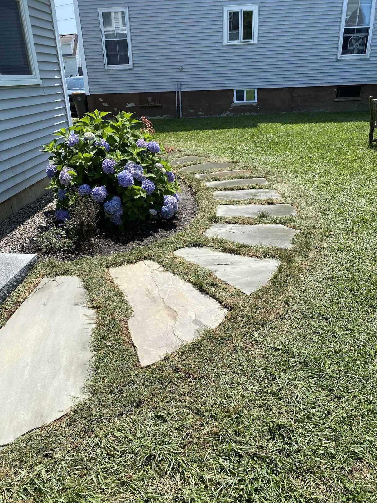 Crescent-shaped paver patio