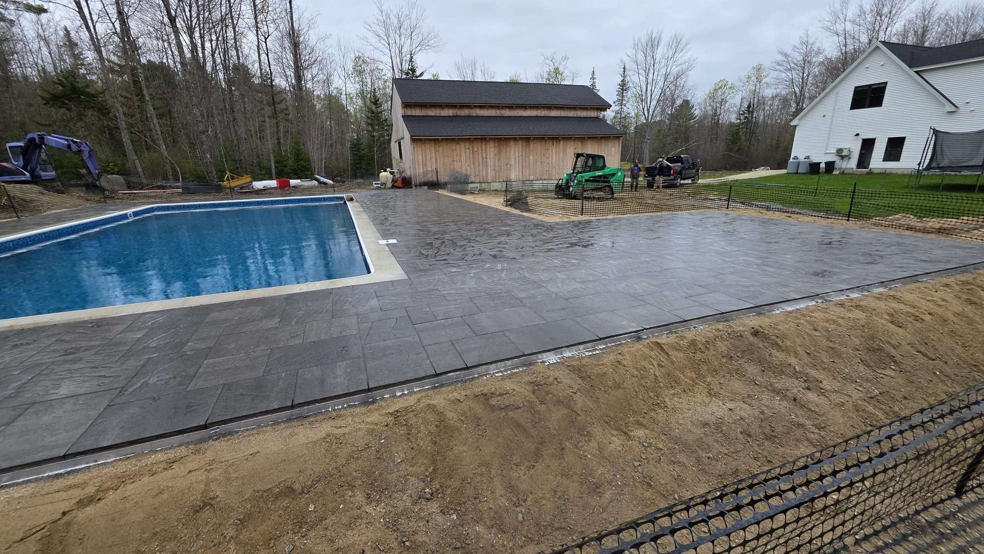 Paver pool patio beside an in-ground pool, Freeport