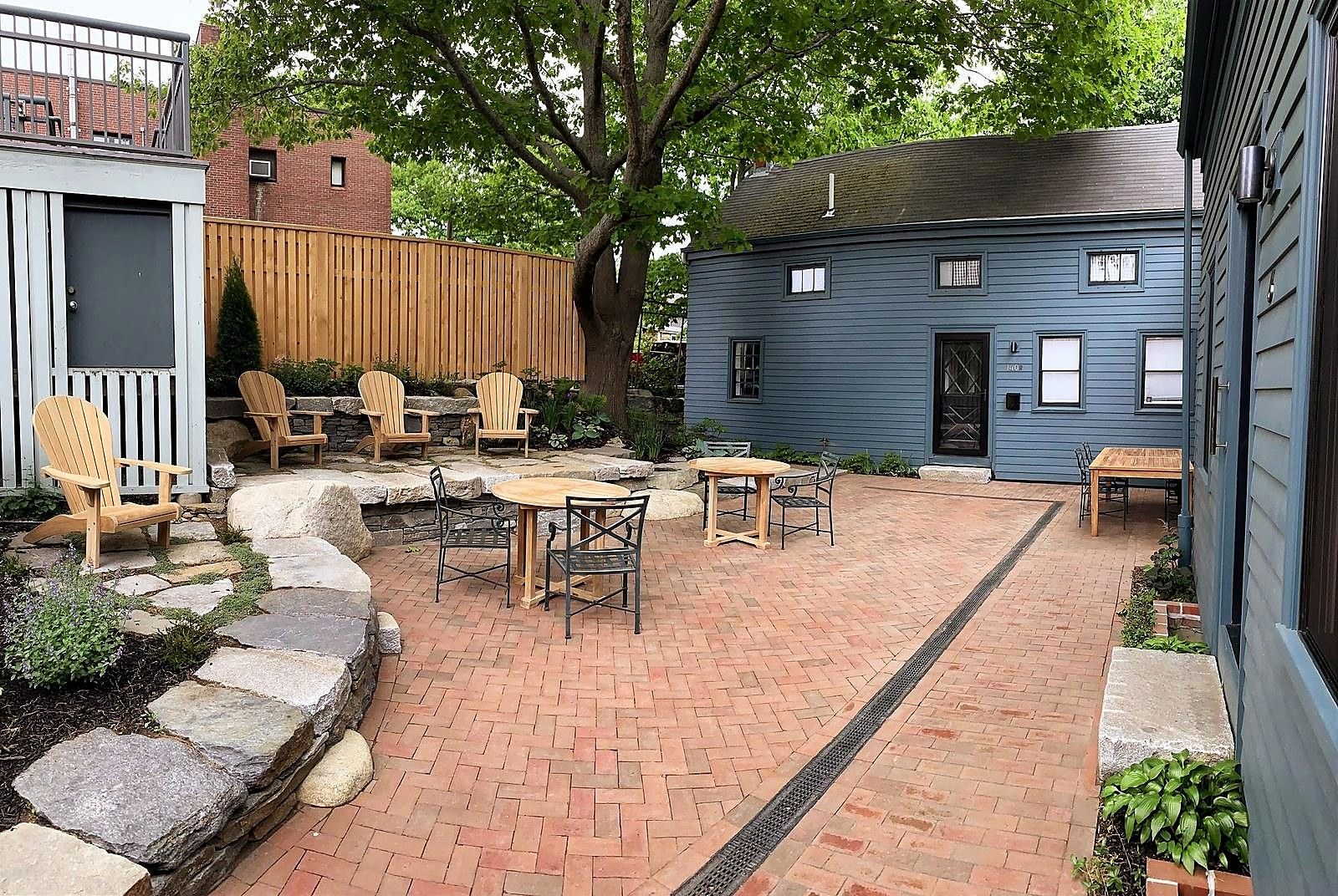 Brick courtyard with stone terracing and cafe seating