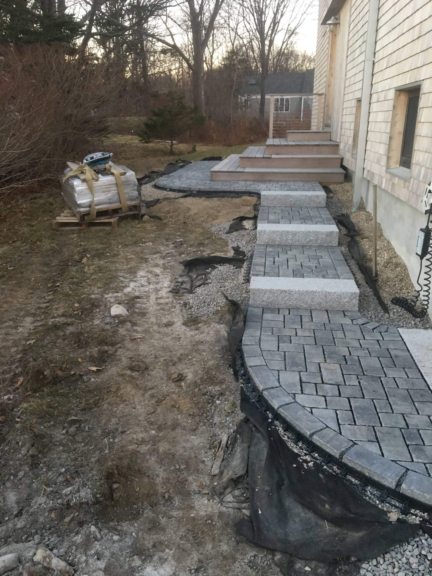 Paver patio with adjoining stone stairs