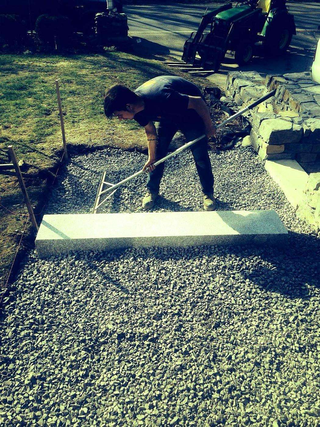 Stone being leveled and set on the finished base