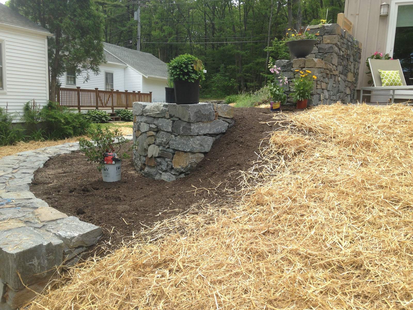 Setting stone in the rain along the wall's edge