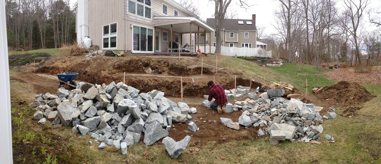 Setting stone on the tiered wall behind the house