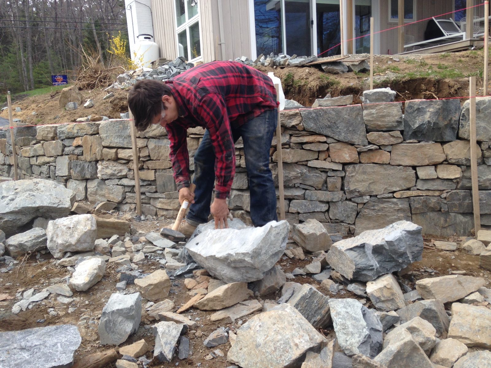 Setting stone on the tiered wall, view toward the house