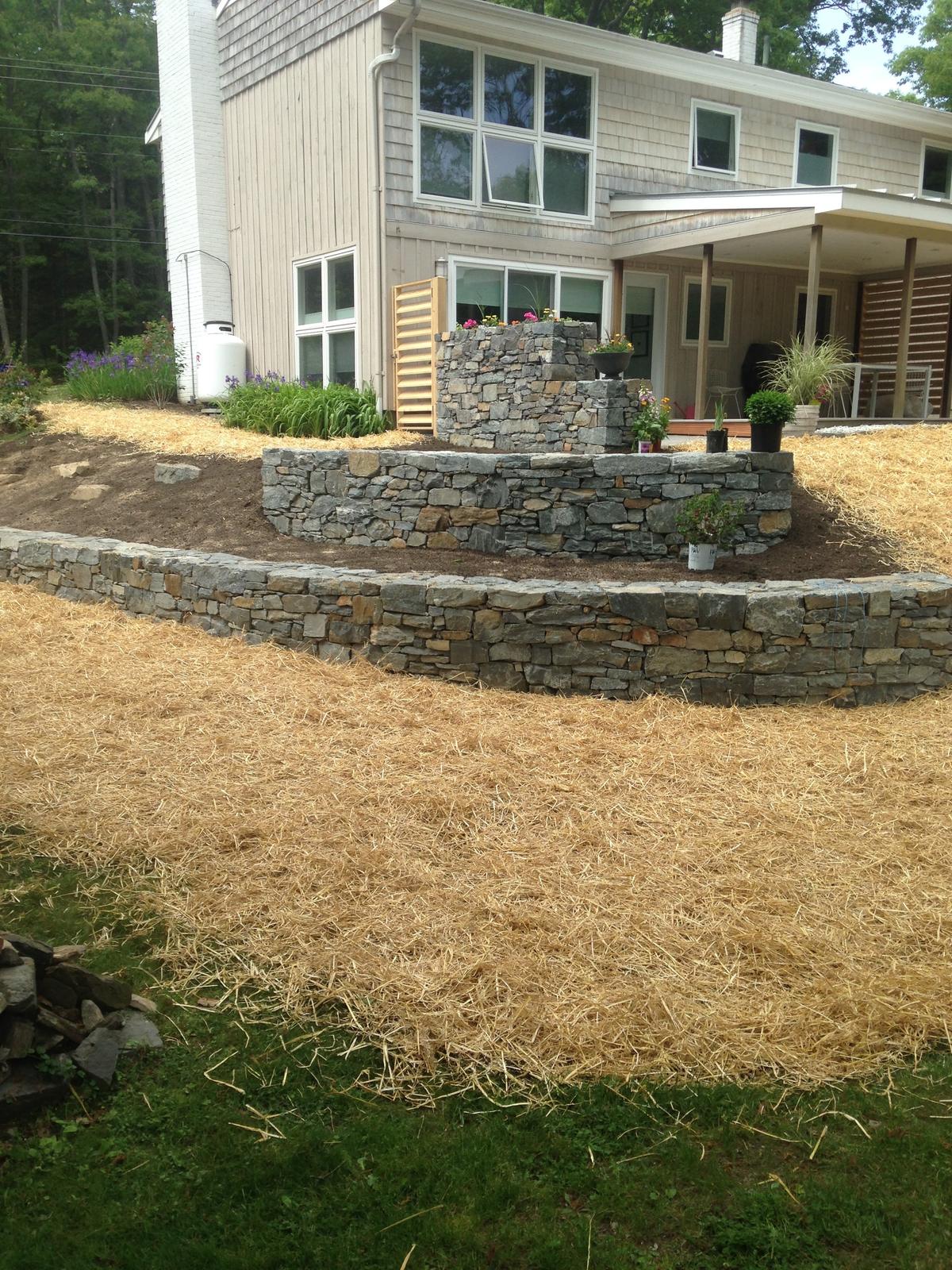 Finished stone walls with straw mulch, ready for planting