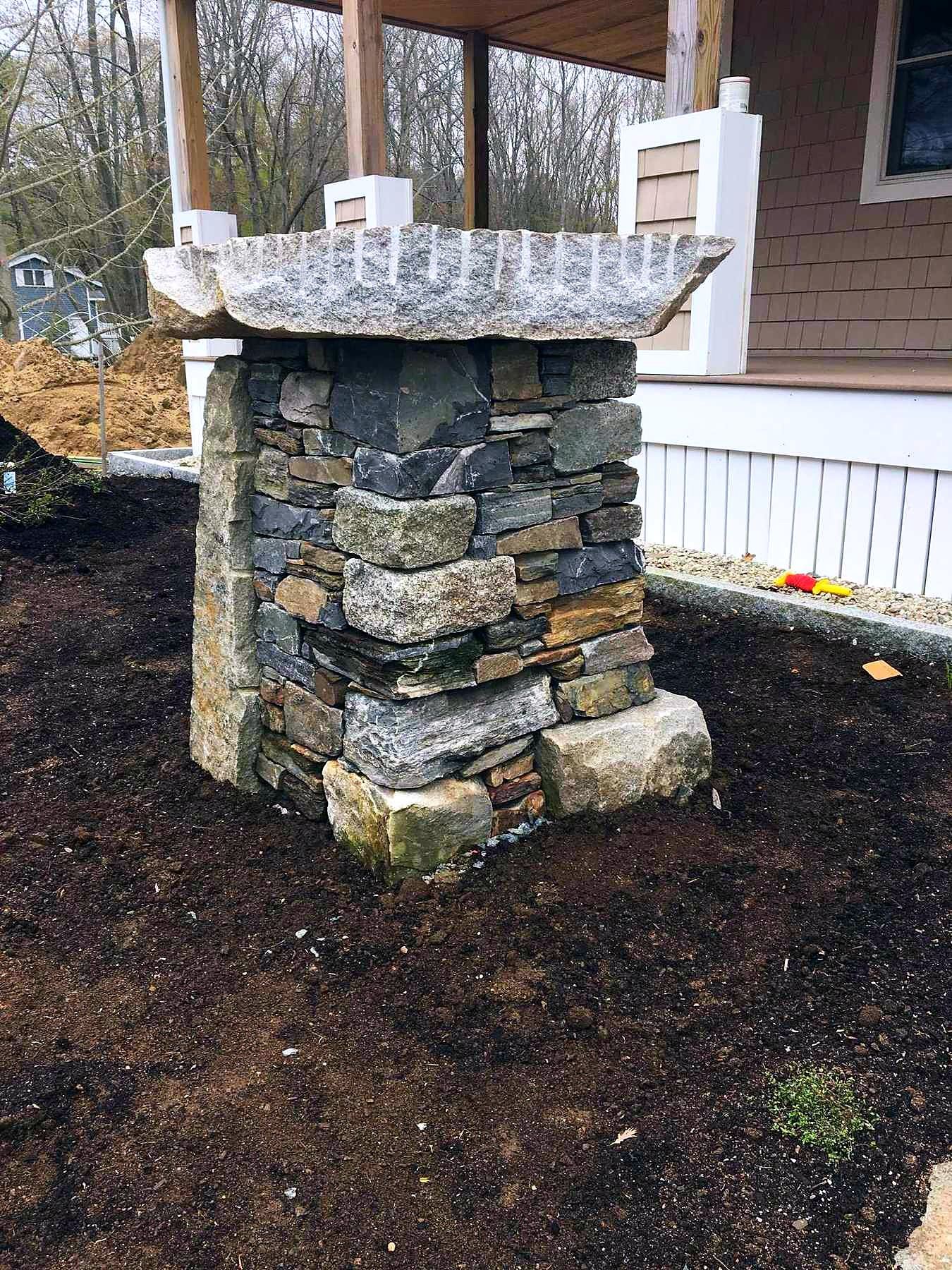 Custom stone pillar in a garden setting