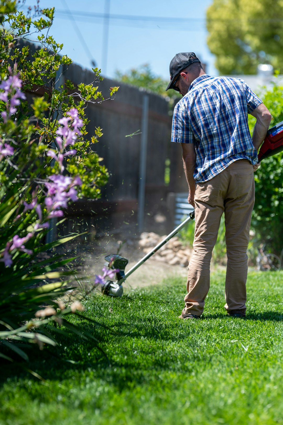 about-img Man edging a lawn with a weed eater